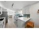 Bright kitchen with white cabinets, blue backsplash, stainless appliances and breakfast bar with seating at 6229 Raven Run, Lakeland, FL 33809