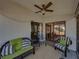 Cozy screened lanai with cushioned seating and a ceiling fan for comfort at 6229 Raven Run, Lakeland, FL 33809