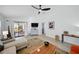 Bright living room with vaulted ceilings, neutral walls, modern furnishings, and sliding glass doors at 6229 Raven Run, Lakeland, FL 33809