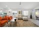 Bright living room featuring a modern sofa, stylish chairs, area rug and sliding glass doors to a patio at 6229 Raven Run, Lakeland, FL 33809