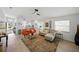 Spacious living room with modern decor, hardwood floors, and a seamless flow into the kitchen at 6229 Raven Run, Lakeland, FL 33809