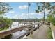 Scenic view of wooden dock extending into the serene lake with tree coverage, offering a peaceful escape at 917 Keep Way Loop, Oviedo, FL 32765