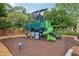 Neighborhood playground with a green slide, climbing structure and a bench with tree coverage at 917 Keep Way Loop, Oviedo, FL 32765