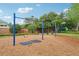 Neighborhood playground with swings, surrounded by green space and mature trees at 917 Keep Way Loop, Oviedo, FL 32765