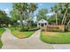 Royalwood Park entrance sign with a gazebo, manicured shrubs and a sidewalk at 917 Keep Way Loop, Oviedo, FL 32765