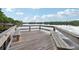 Wooden dock featuring built-in seating overlooking a serene lake and picturesque surroundings at 917 Keep Way Loop, Oviedo, FL 32765