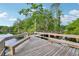 Picturesque wooden dock with benches surrounded by lush greenery and calm waters at 917 Keep Way Loop, Oviedo, FL 32765