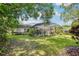 Expansive backyard features a screened-in pool, mature trees, and a well-maintained lawn at 917 Keep Way Loop, Oviedo, FL 32765