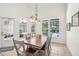 Sunlit dining area offers backyard views, stylish lighting, and easy access to outdoor spaces at 917 Keep Way Loop, Oviedo, FL 32765