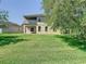 A beautiful backyard with a large tree and green lawn at 1705 Plantation Pointe Dr, Orlando, FL 32824