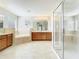Open-concept bathroom with tiled floor, stand-up shower, soaking tub, and and sinks at 1705 Plantation Pointe Dr, Orlando, FL 32824