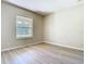 Bright bedroom with wood-look flooring and a large window showcasing the outdoor view at 1705 Plantation Pointe Dr, Orlando, FL 32824