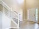 Inviting entryway features tiled floors, staircase with white railings, and front door with sidelights at 1705 Plantation Pointe Dr, Orlando, FL 32824