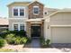 Beautiful home featuring a stone entryway, a well-manicured lawn, and lots of natural light at 1705 Plantation Pointe Dr, Orlando, FL 32824