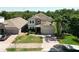 Charming two-story home boasting a stone facade, attached garage, brick driveway, and manicured lawn at 1705 Plantation Pointe Dr, Orlando, FL 32824