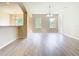 Open living area with wood floors, large windows, and light neutral paint at 1705 Plantation Pointe Dr, Orlando, FL 32824