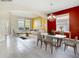 Staged living and dining area with stylish furnishings, vibrant walls, and ample natural light at 1705 Plantation Pointe Dr, Orlando, FL 32824