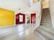 Open-concept living space showcasing modern flooring, a staircase, and vibrant accent walls at 1705 Plantation Pointe Dr, Orlando, FL 32824