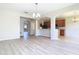 Spacious living room features modern flooring, chandelier, and access to the kitchen area at 1705 Plantation Pointe Dr, Orlando, FL 32824