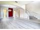 Spacious living room with modern flooring, archways, and staircase with carpeted steps at 1705 Plantation Pointe Dr, Orlando, FL 32824