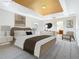 Relax in this spacious main bedroom suite with decorative tray ceiling and ensuite bathroom at 1705 Plantation Pointe Dr, Orlando, FL 32824