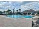 Community pool area featuring an oversized pool, lounge chairs, and a clubhouse at 1705 Plantation Pointe Dr, Orlando, FL 32824