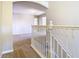 Hallway with white railing overlooking the carpeted stairs and leading into the rooms at 1705 Plantation Pointe Dr, Orlando, FL 32824