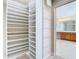 Spacious walk-in closet featuring custom shelving units and adjacent bathroom access at 1705 Plantation Pointe Dr, Orlando, FL 32824
