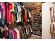 Bright walk-in closet with hanging clothes, handbags on shelves, and shoe racks at 1705 Plantation Pointe Dr, Orlando, FL 32824