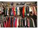 Organized walk-in closet with hanging clothes, handbags, and hats on shelves at 1705 Plantation Pointe Dr, Orlando, FL 32824