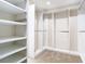 This organized walk-in closet features ample shelving and rods for optimal storage solutions at 1705 Plantation Pointe Dr, Orlando, FL 32824