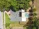 Aerial view of home with screened pool, solar panels, large trees, fenced yard, and brick driveway at 2170 Lake Marion Dr, Apopka, FL 32712
