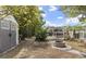 Home's backyard features a brick fire pit, landscaping, and a screened-in pool at 2170 Lake Marion Dr, Apopka, FL 32712