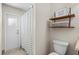A bathroom with open shelves and a toilet next to the shower at 2170 Lake Marion Dr, Apopka, FL 32712