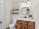 Bathroom with a decorative mirror, open shelves, and a wooden vanity at 2170 Lake Marion Dr, Apopka, FL 32712