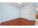 A blue bedroom with wood floors and a closet at 2170 Lake Marion Dr, Apopka, FL 32712