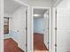 View through open doors of bedroom with wood floors, painted walls and a window at 2170 Lake Marion Dr, Apopka, FL 32712
