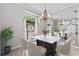 Elegant dining room featuring a modern table, stylish chairs, and a decorative mirror at 2170 Lake Marion Dr, Apopka, FL 32712