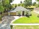 Charming single-story home with a well-manicured lawn, brick driveway, and attached two-car garage at 2170 Lake Marion Dr, Apopka, FL 32712