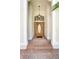 Inviting entryway featuring a wood door with glass, brick steps, and overhead lighting at 2170 Lake Marion Dr, Apopka, FL 32712