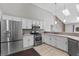 Bright kitchen features stainless steel appliances, white cabinets, and modern countertops at 2170 Lake Marion Dr, Apopka, FL 32712
