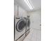 Laundry room with LG washer and dryer and white tile floors at 2170 Lake Marion Dr, Apopka, FL 32712