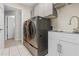 Spacious laundry room featuring newer washer and dryer and utility sink at 2170 Lake Marion Dr, Apopka, FL 32712