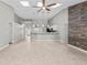 Open living area with vaulted ceilings, skylights, wood accent wall, and tile flooring at 2170 Lake Marion Dr, Apopka, FL 32712