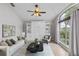 Cozy living room with a murphy bed, large windows, and a ceiling fan for comfort at 2170 Lake Marion Dr, Apopka, FL 32712