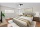 Bedroom features a king size bed, ceiling fan, wood floors, and a decorative painting at 2170 Lake Marion Dr, Apopka, FL 32712