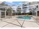 Beautiful enclosed pool area, featuring a spa, neutral patio, and tropical landscaping at 2170 Lake Marion Dr, Apopka, FL 32712