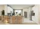 Modern kitchen featuring stainless steel appliances, a central island with seating, and plenty of natural light at 2203 Rider Rain Ln, Apopka, FL 32703