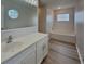 Well-lit bathroom with vanity and a soaking tub under window at 105 Evergreen Dr, Auburndale, FL 33823