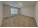 An empty bedroom with a light beige carpet, lots of open space and natural light from the single window at 105 Evergreen Dr, Auburndale, FL 33823